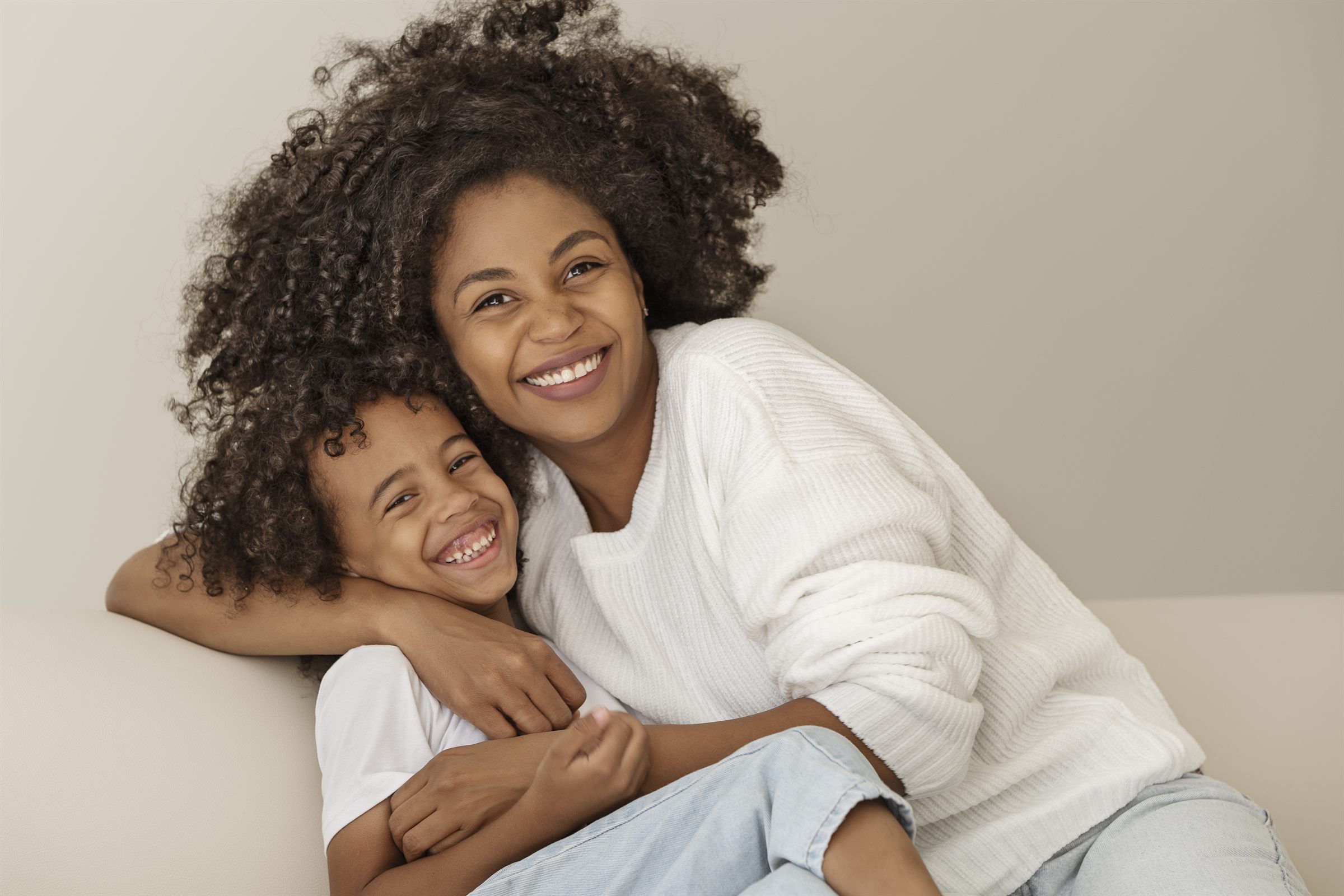 A smiling mother and her young daughter